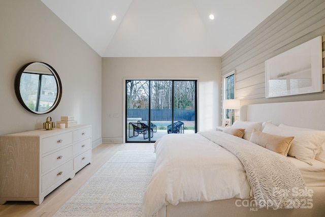 bedroom with access to exterior, recessed lighting, light wood-type flooring, and high vaulted ceiling