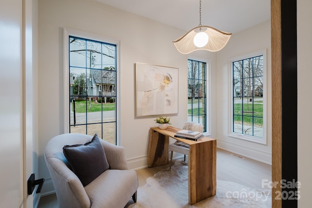 office space featuring visible vents, baseboards, and light wood-style floors