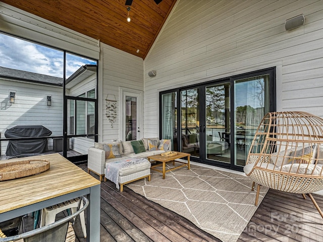 wooden terrace featuring an outdoor living space and grilling area