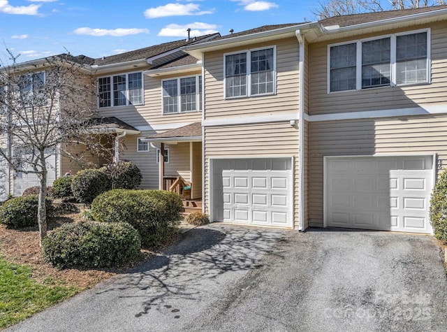 townhome / multi-family property with an attached garage and driveway