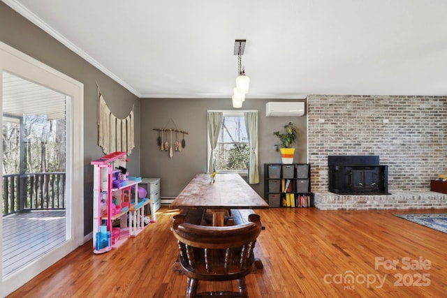 33 Milburn Ln, Hendersonville, NC 28792 - dining space featuring an AC wall unit, wood finished floors, crown molding, baseboard heating, and a wood stove