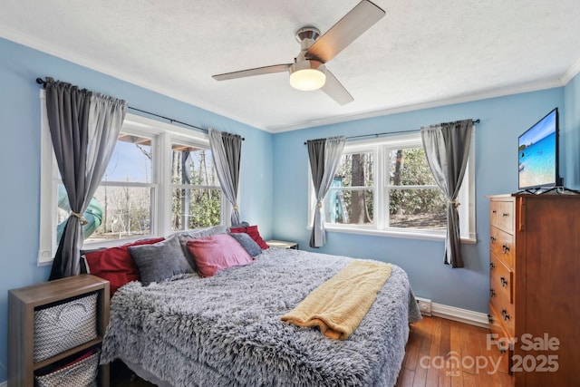 33 Milburn Ln, Hendersonville, NC 28792 - bedroom featuring crown molding, baseboards, a textured ceiling, a ceiling fan, and wood-type flooring