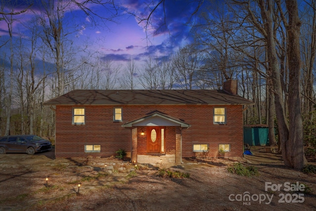 33 Milburn Ln, Hendersonville, NC 28792 - view of front of house featuring brick siding and a chimney