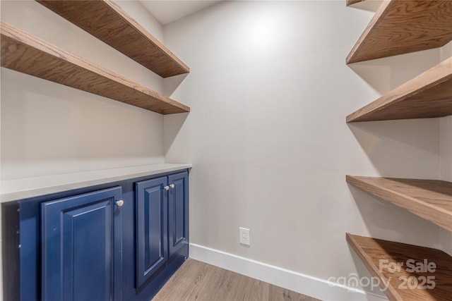 bar with light wood finished floors and baseboards