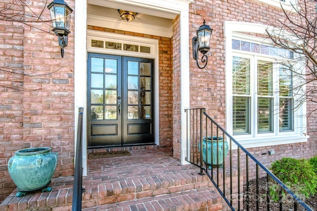 doorway to property with french doors and brick siding