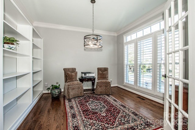 living area with visible vents, crown molding, and wood finished floors