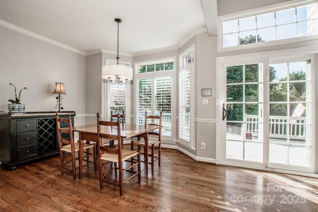 dining room with baseboards, a notable chandelier, dark wood-style floors, and crown molding