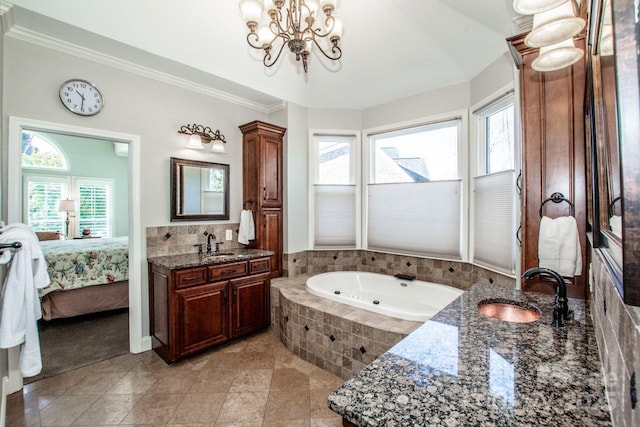 bathroom featuring crown molding, a chandelier, vanity, a tub with jets, and ensuite bath