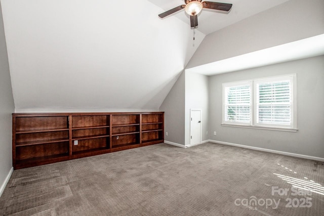 additional living space with baseboards, lofted ceiling, carpet floors, and ceiling fan