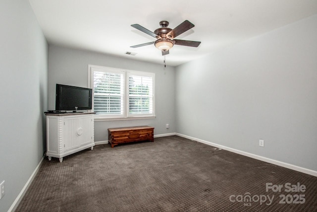 unfurnished bedroom featuring visible vents, ceiling fan, baseboards, and dark colored carpet