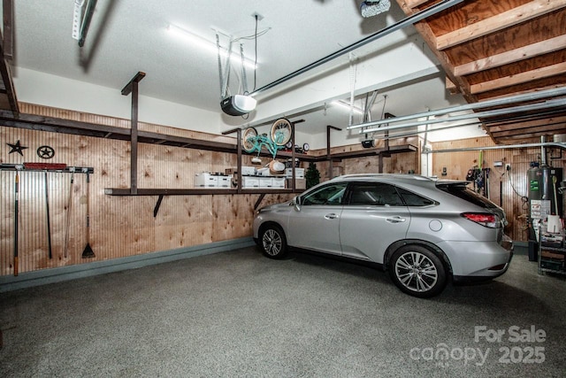 garage featuring gas water heater and a garage door opener