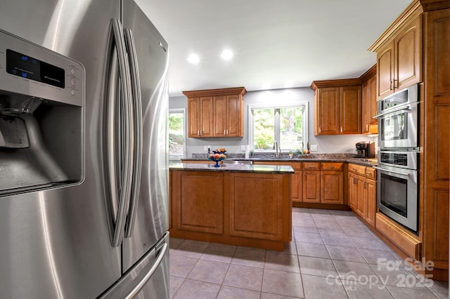 97 Ballantree Dr, Asheville, NC 28803 - kitchen with appliances with stainless steel finishes, brown cabinets, light tile patterned floors, and recessed lighting