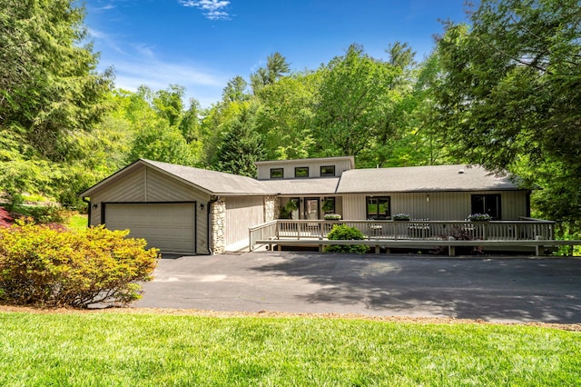 97 Ballantree Dr, Asheville, NC 28803 - mid-century home with a garage, driveway, and a wooden deck