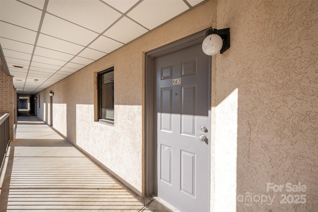 entrance to property featuring stucco siding