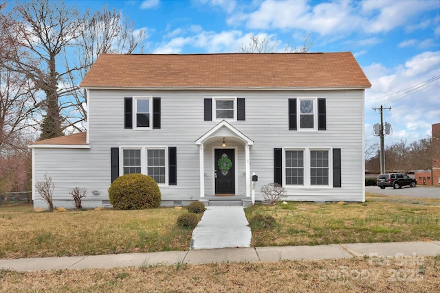 colonial home featuring crawl space and a front lawn