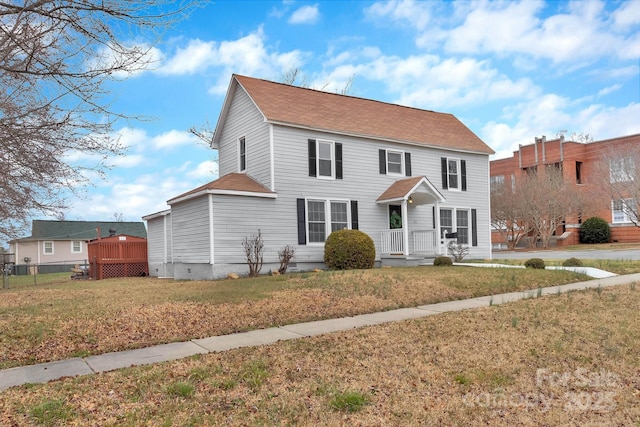 colonial inspired home with crawl space, fence, and a front lawn