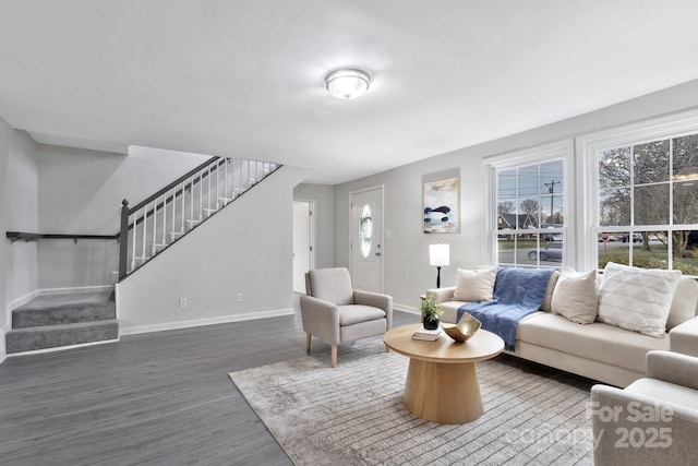 living room with stairway, wood finished floors, and baseboards