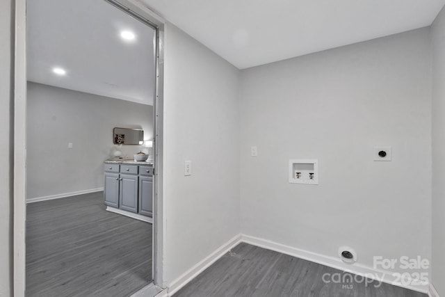 washroom with dark wood-style floors, washer hookup, electric dryer hookup, laundry area, and baseboards