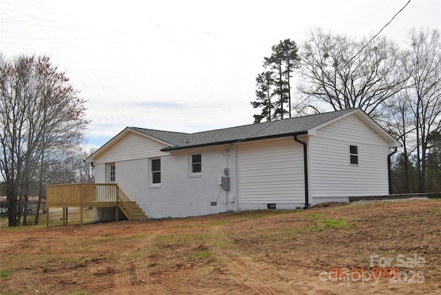 exterior space featuring stairs, a deck, roof with shingles, and crawl space