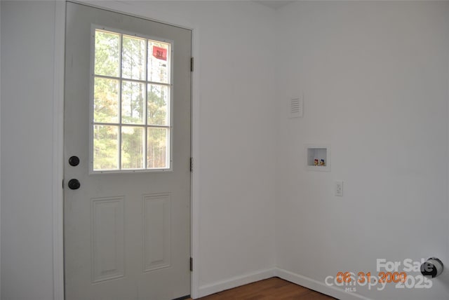 doorway featuring wood finished floors and baseboards