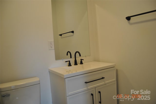 bathroom featuring vanity and toilet