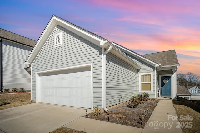 view of front of property with concrete driveway and an attached garage