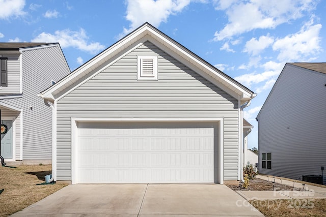 view of front facade featuring an outbuilding, driveway, central AC, and a garage