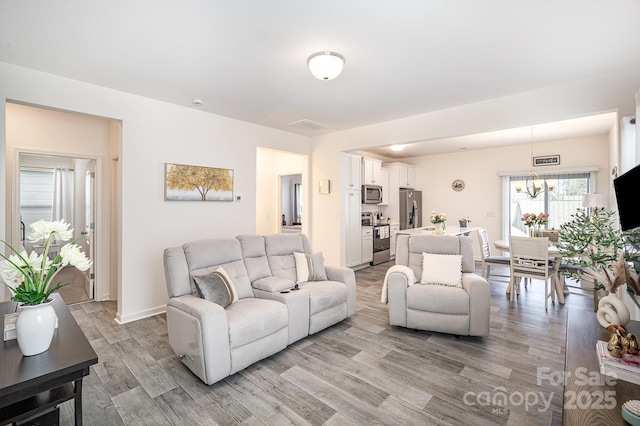 living room featuring baseboards and light wood-style floors