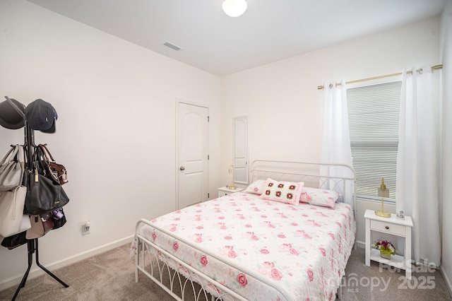 carpeted bedroom with visible vents and baseboards