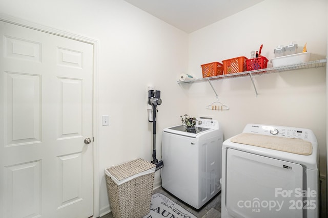 clothes washing area with laundry area and washer and clothes dryer