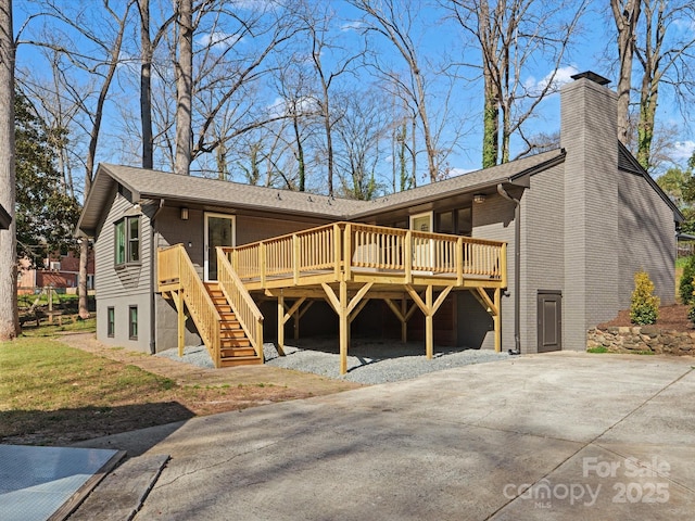 view of front of property with a wooden deck, stairway, brick siding, and a chimney