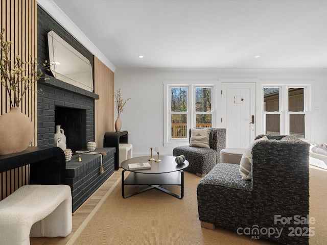 living room with recessed lighting, a brick fireplace, crown molding, and wood finished floors