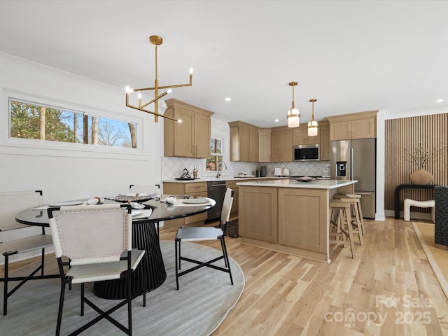 dining space with recessed lighting, light wood-type flooring, and a chandelier