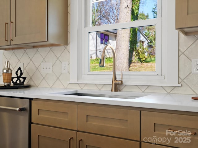 kitchen featuring a sink, decorative backsplash, and light countertops