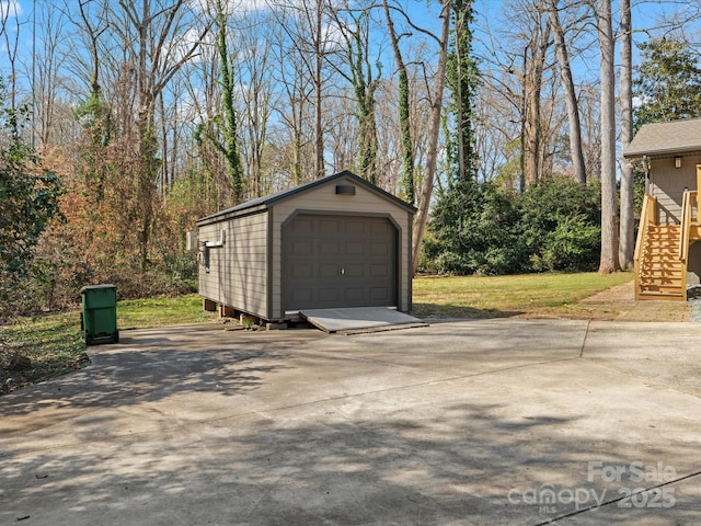 detached garage with concrete driveway