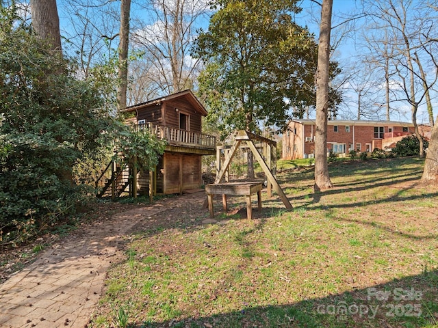 view of yard featuring stairway and a deck