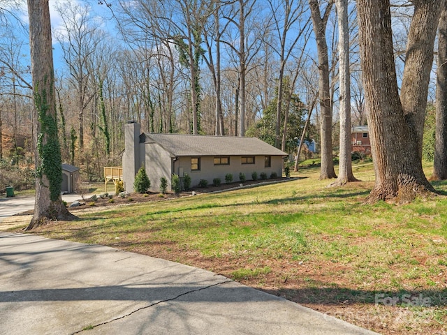 view of front of property with a chimney and a front yard