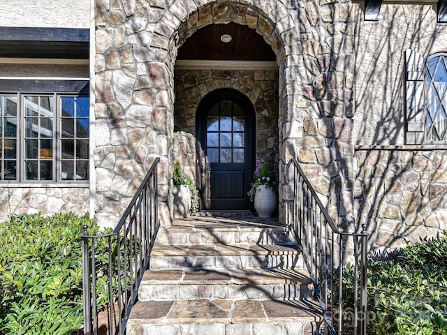 doorway to property with stone siding