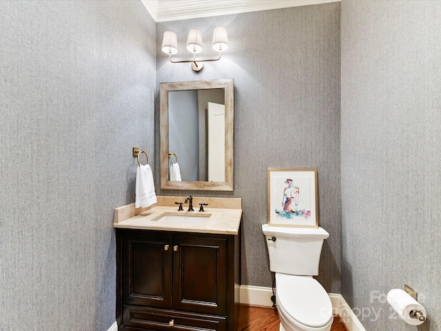 bathroom with toilet, wood finished floors, and vanity