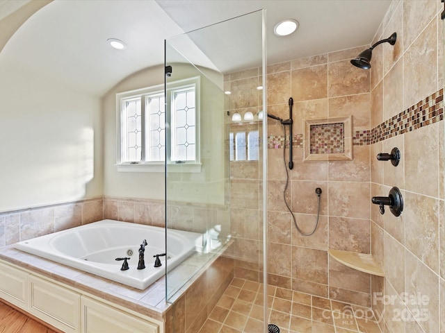 full bathroom featuring a bath, recessed lighting, and tiled shower