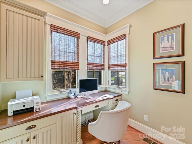 office space featuring wood finished floors, baseboards, and ornamental molding