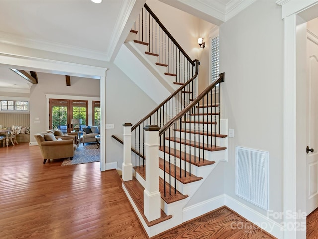 stairs featuring wood finished floors, visible vents, baseboards, french doors, and crown molding