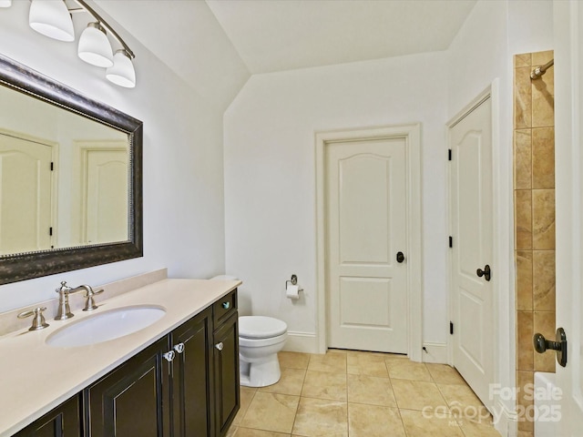 full bath featuring tile patterned floors, toilet, tiled shower, and vanity