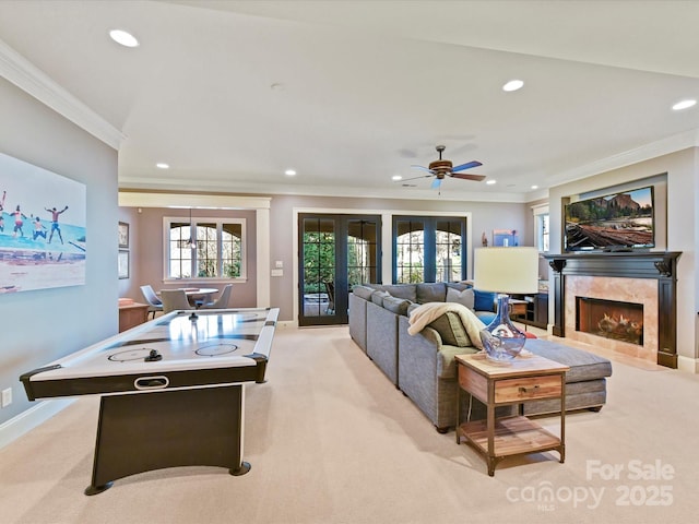 living area featuring recessed lighting, light colored carpet, baseboards, and ornamental molding