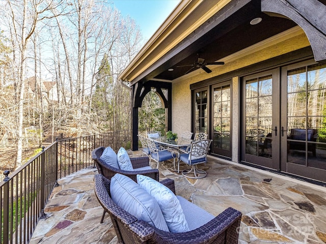 view of patio / terrace featuring french doors, outdoor dining area, and ceiling fan