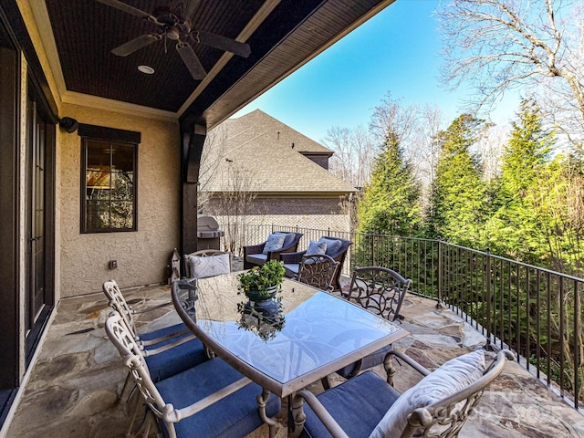 view of patio featuring outdoor dining area and a ceiling fan