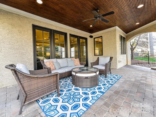 view of patio / terrace with an outdoor living space, a ceiling fan, and fence