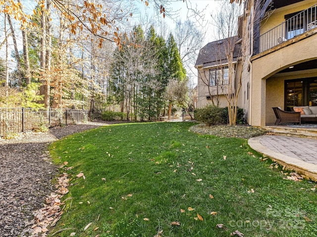 view of yard featuring a patio and fence