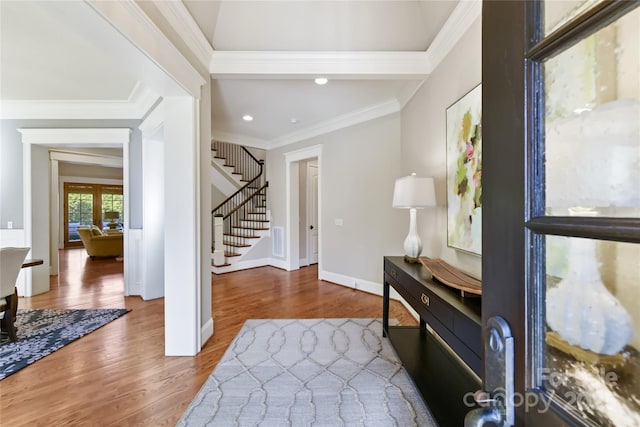 entrance foyer featuring visible vents, wood finished floors, stairway, crown molding, and baseboards