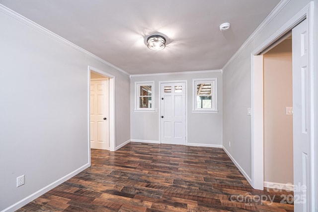 foyer entrance featuring dark wood finished floors, baseboards, and ornamental molding